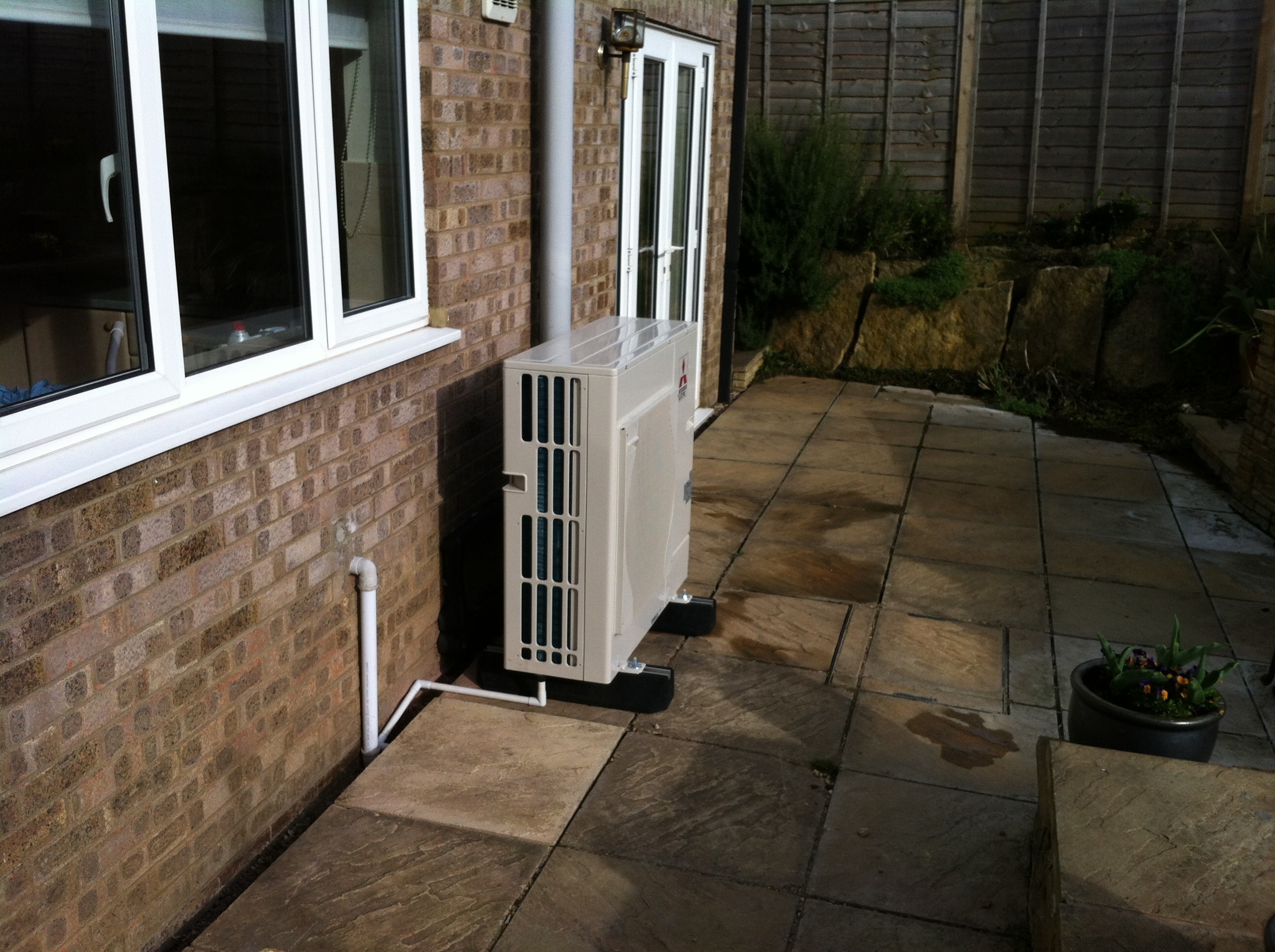 image of air source heat pumps fitted around rear of house